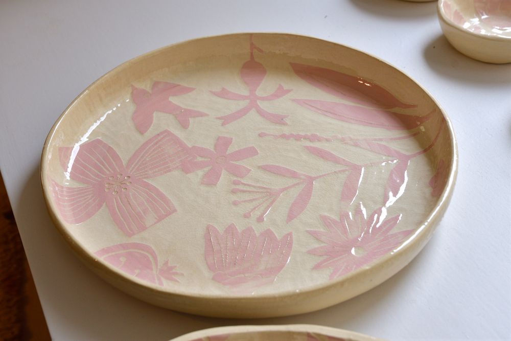 a plate with pink painted flowers